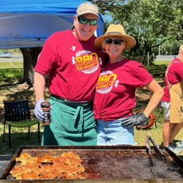 Volunteers cooking food at the South Tampa BBQ Fundraiser. 