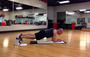 man holding plank during core workout