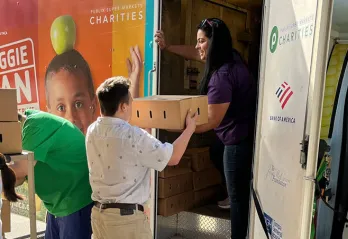 Elizabeth Roman unloading the Veggie Van.