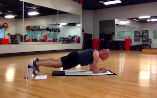 man holding plank during core workout