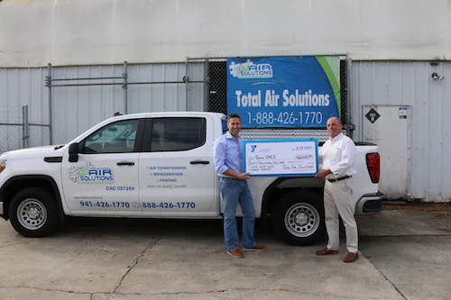 Total Air Solutions presents check to Tampa YMCA.