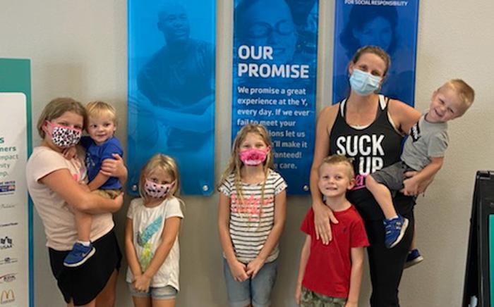 Mom with six children wearing face coverings at the Y