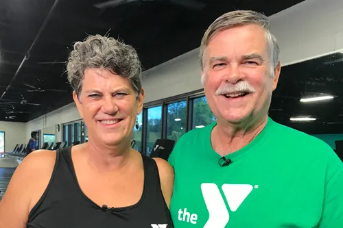 Man and woman side hugging at the YMCA