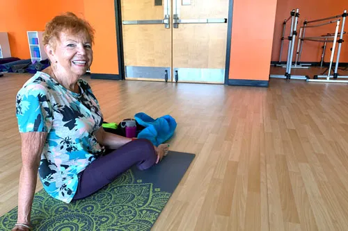 An active older adult prepares for stretch class.