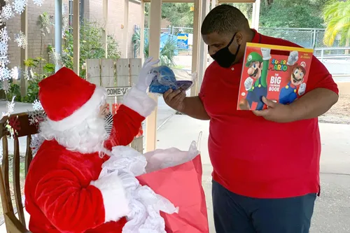 Santa giving presents at Lopez Exceptional Student Center in Seffner