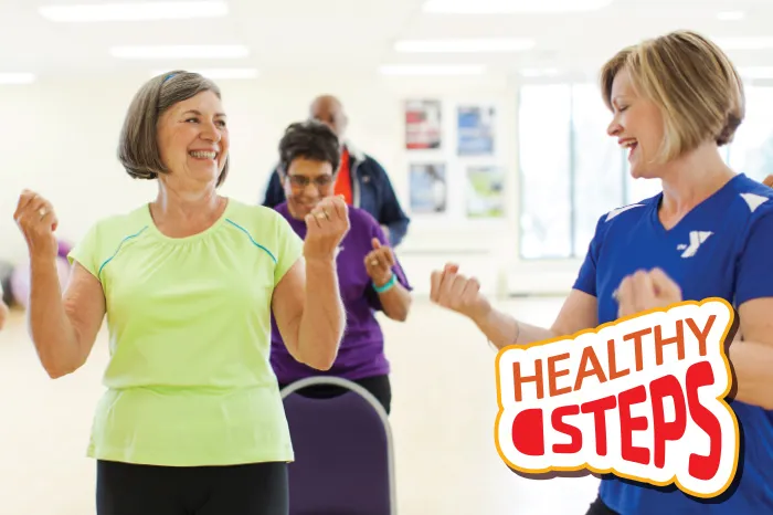 Woman exercising with YMCA staff member. Text reads healthy steps (logo)