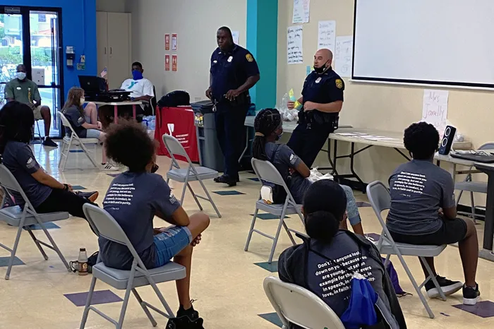 Tampa Y Teen Achievers participants talk with local police officers.