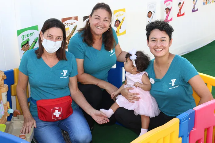 Group of three female Early Head Start staff with a baby.