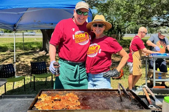 Volunteers cooking food at the South Tampa BBQ Fundraiser.&nbsp;