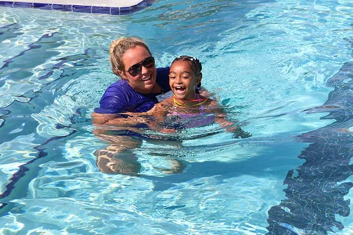 Morgan works with a younger swimmer on her strokes.