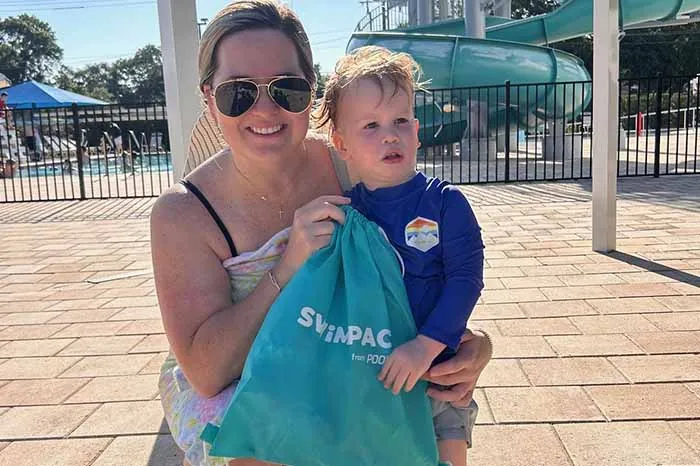 A child and his mother at the YMCA and POOLCORP SWIMPACT event.