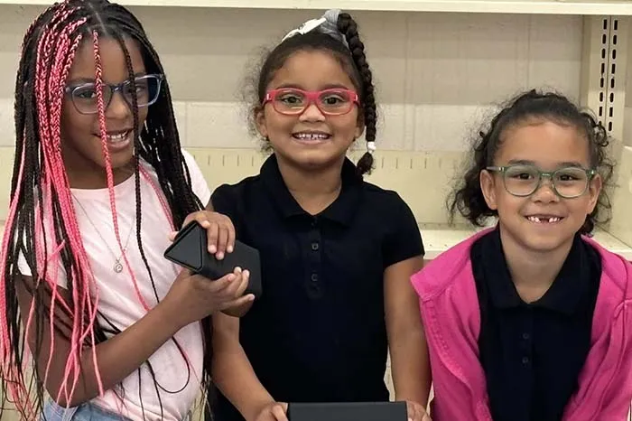 Promiyse Quick (first from left) and her friends loved their new eye glasses.