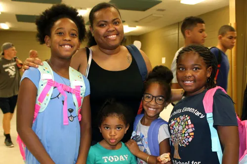 https://www.tampaymca.org/wp-content/uploads/2019/08/backpack-outreach-family.jpg