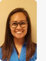 headshot of female personal trainer wearing blue YMCA polo beige background