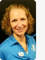 headshot of female personal trainer wearing blue YMCA polo black background