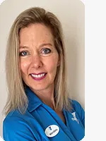 headshot of female personal trainer wearing blue YMCA polo beige background
