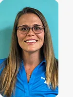 headshot of personal trainer with glasses wearing blue shirt teal background