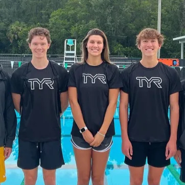 Five TYS swimmers pose after a big win