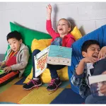 Three children reading and having fun!